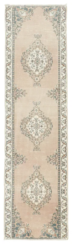 Full top view of the vintage Anatolian runner rug with tan field and geometric medallions.