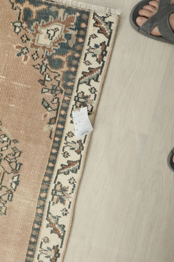 Close-up of the rug's low pile and knotting, with a small tag visible.