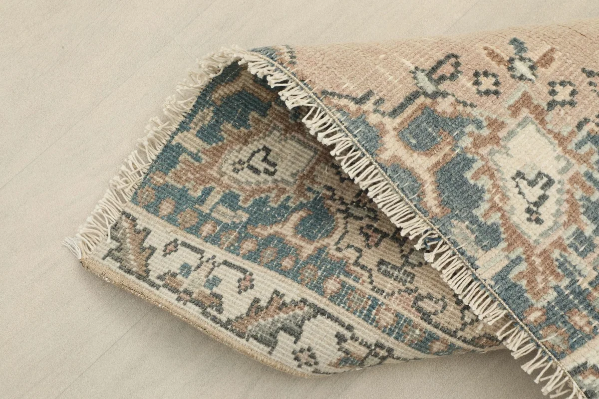Corner of the runner folded to show the thickness and flexibility of the rug.