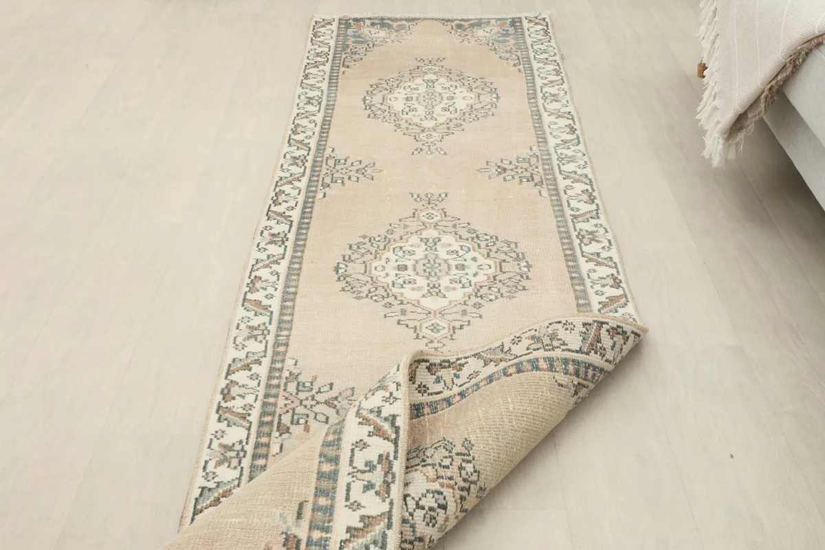 Runner partially rolled, displaying the full length of the rug and its patterns.