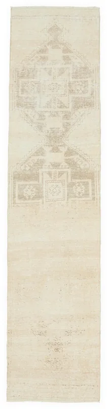 Full overhead view of the 2'9" x 11'8" ivory and beige geometric vintage runner rug on a white background.