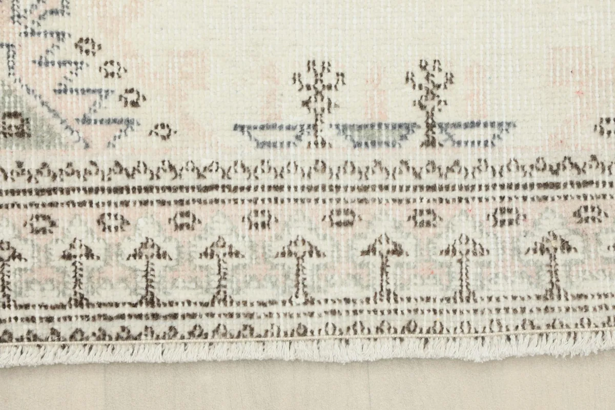 Close-up of the rug's border and fringe, showcasing the traditional Anatolian patterns and natural wear.