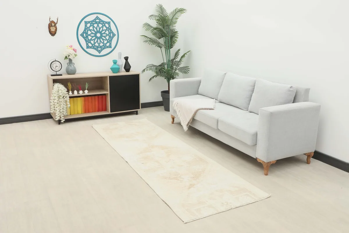 Beige vintage runner in a modern living room setting next to a gray sofa