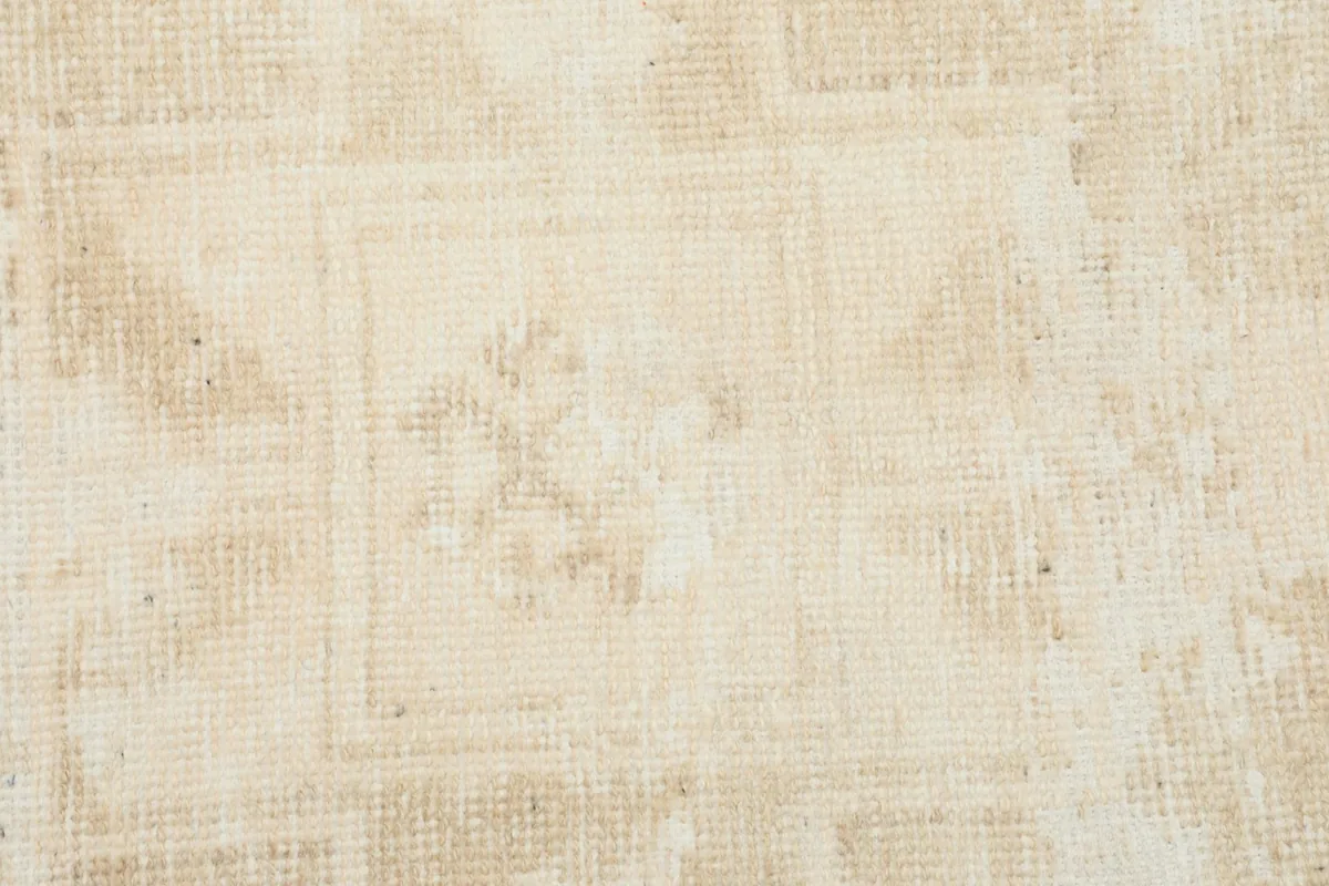 Tight detail of the rug's surface, showing the low pile and subtle weave of the wool
