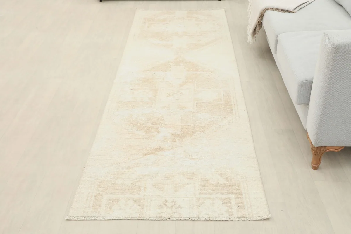 Full overhead view of the beige and tan runner laid out in a room setting
