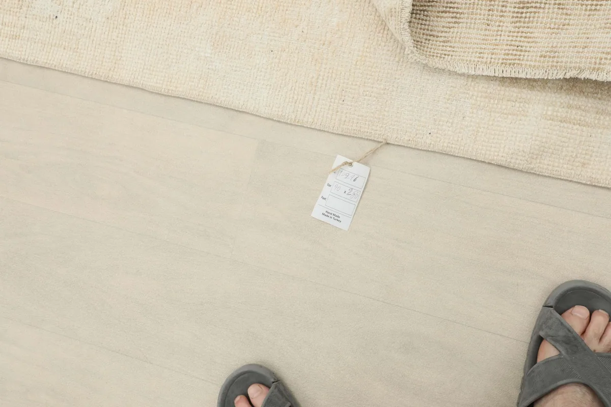 A small tag visible on the floor next to the runner, indicating product information