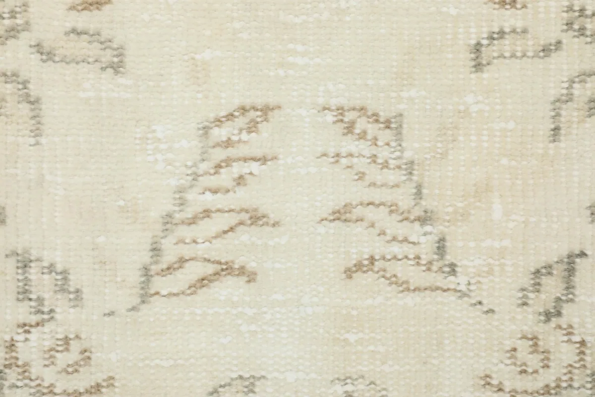 Detailed close-up of the low pile and texture, showing the subtle tan floral weaving.