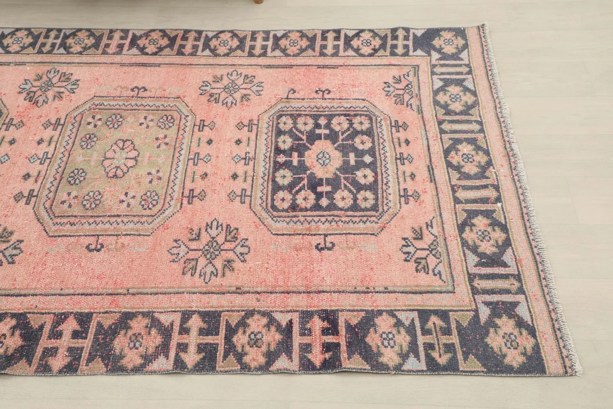 Close-up angle showing the end of the runner, highlighting the navy border and rose field