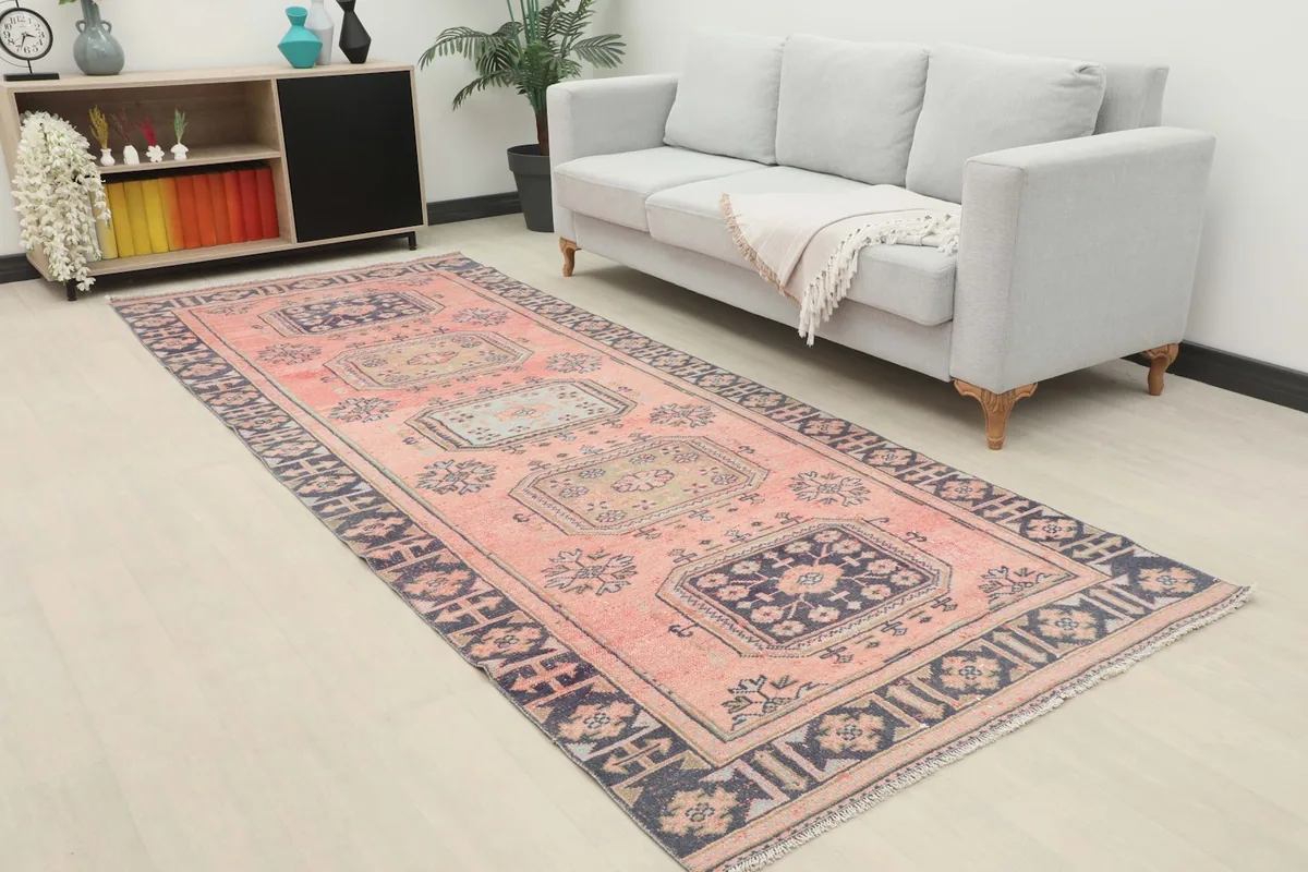 Vintage Anatolian runner displayed in a contemporary living room setting with a gray sofa
