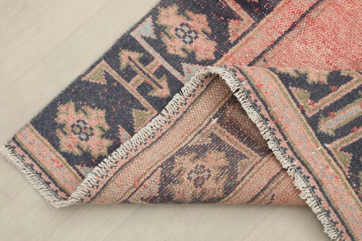 Close-up of the folded corner, showing the fringe and the tight, durable hand-knotted construction