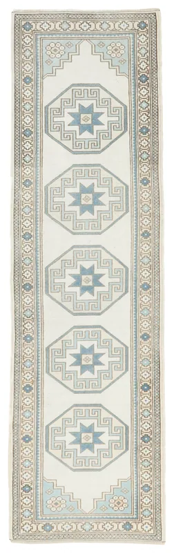 Full overhead view of the vintage cream and blue geometric Anatolian runner rug