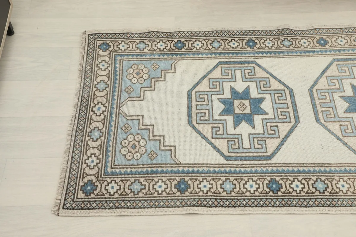 Detail view of the rug's patterns and colors from a different angle in a room