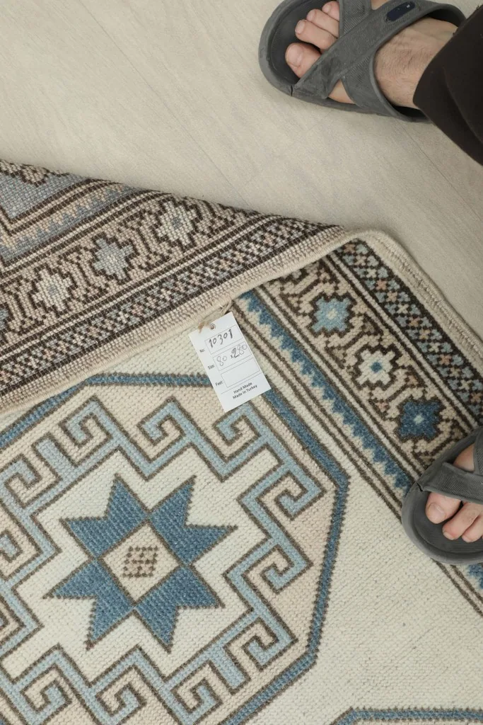 View of the rug's back and foundation, with a tag showing size information