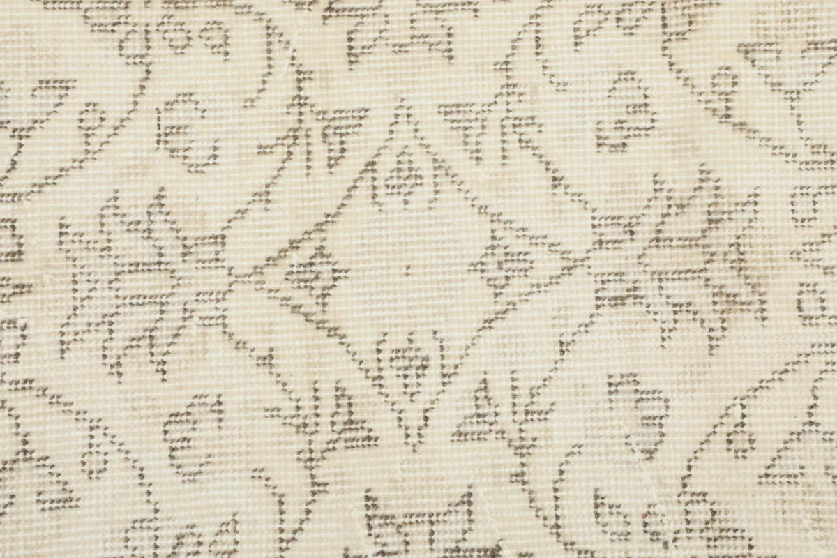 Extremely close-up view of the low pile and hand-knotted texture of the rug.