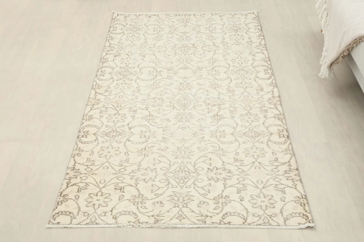 Overhead view of the rug laid flat on a light floor, showing its overall shape and design.
