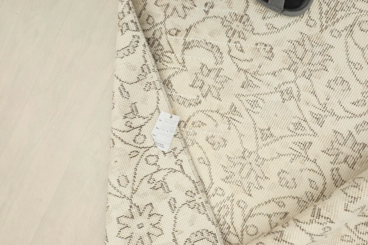 Close-up showing a small, natural imperfection or repair on the rug's surface.