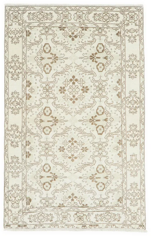 Full top view of the 3'4" x 5'4" ivory and tan vintage Anatolian rug on a white background.