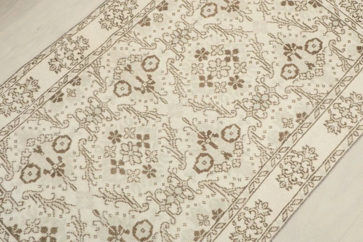 Diagonal view across the rug, emphasizing the repeating floral and geometric motifs.