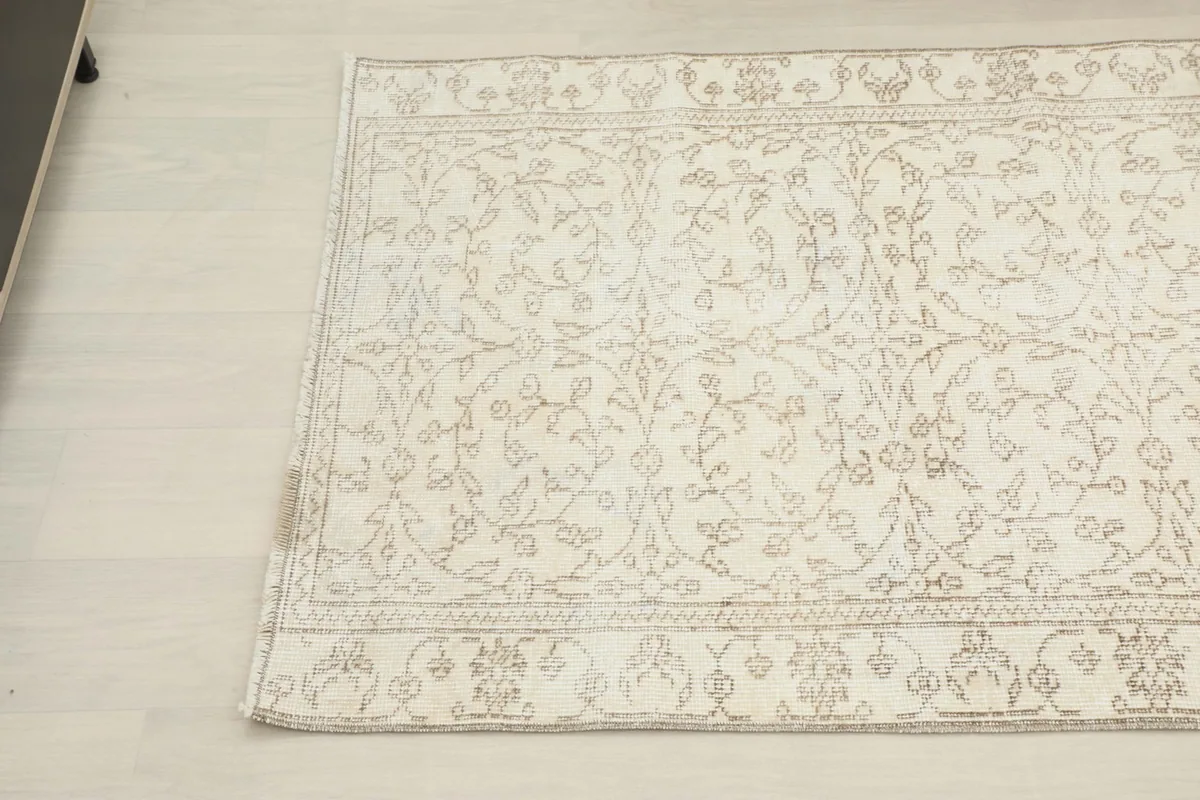 Overhead angled view showcasing the subtle color variations and hand-knotted texture of the rug