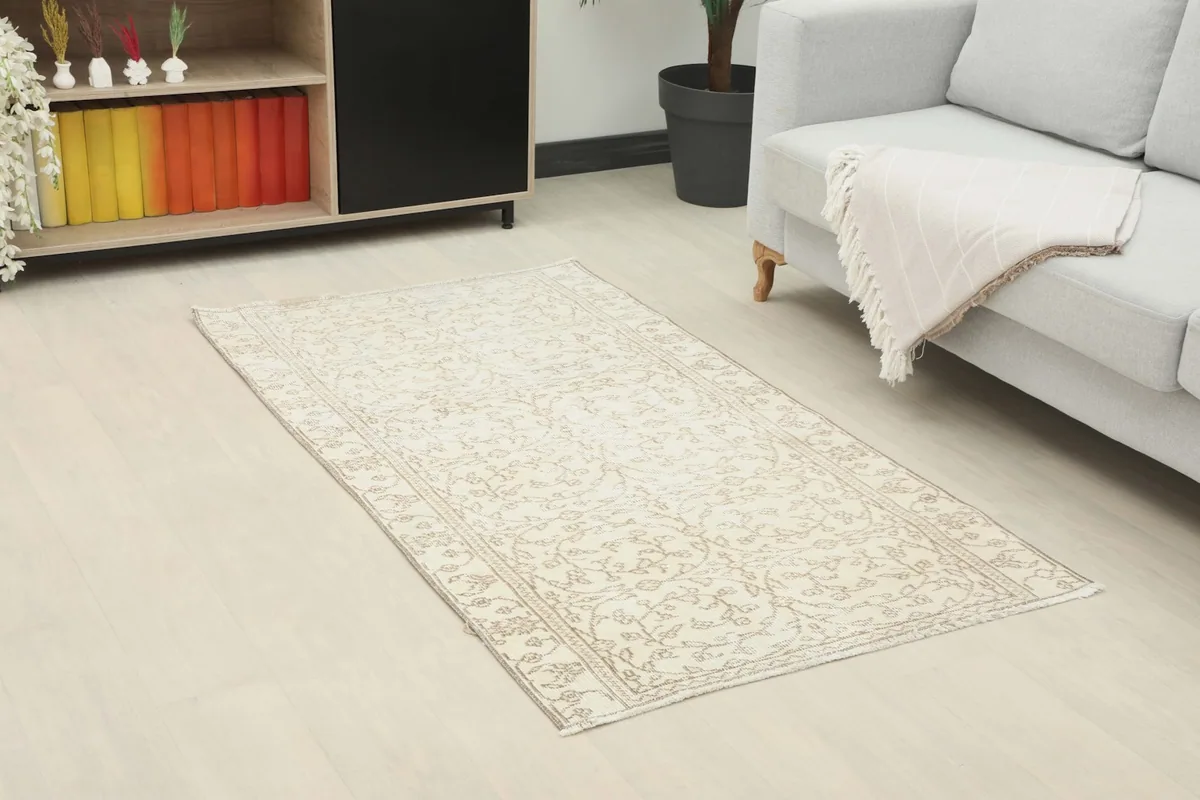 Angled view of the small vintage rug on a light floor, enhancing a contemporary living space