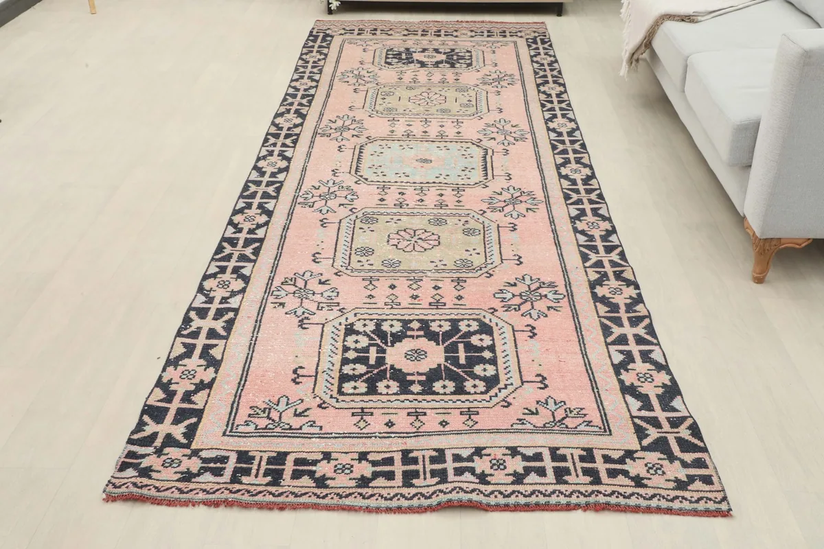 Full overhead view of the pink and navy runner in a room, capturing its overall design and scale