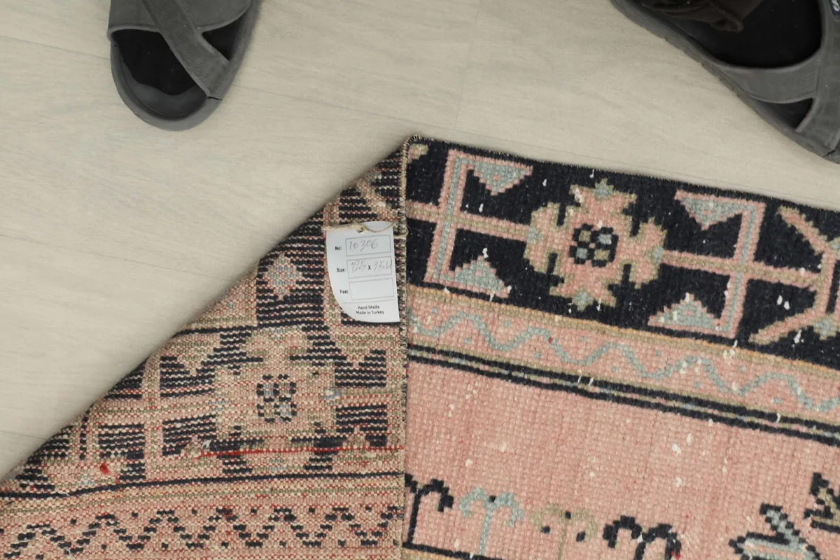 Close-up of the back of the rug, showing the tightly woven hand-knotted wool on cotton foundation