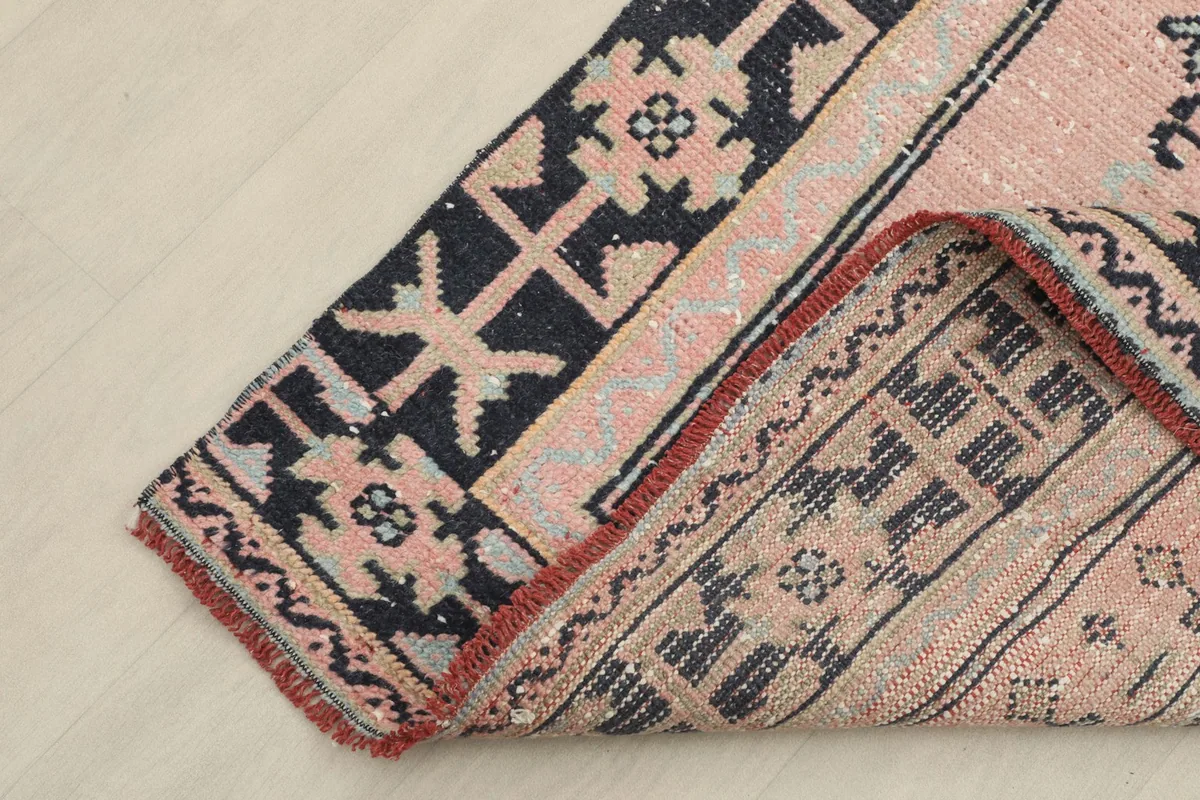 Corner of the runner folded to show the wool pile texture and the cotton foundation