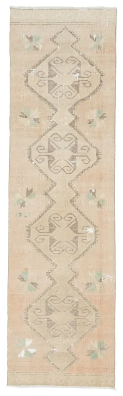 Full overhead view of a beige Anatolian runner rug with gray geometric patterns