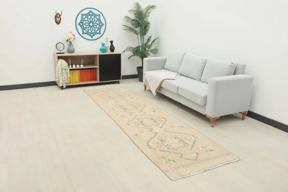 Runner rug displayed in a modern hallway setting with a light gray sofa and side table