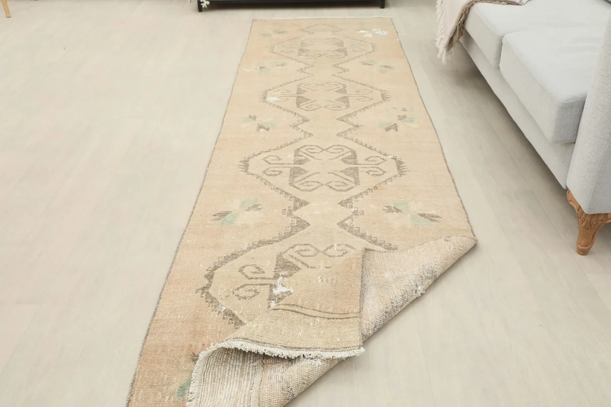 Runner rug with a section folded back, showing the thickness and construction