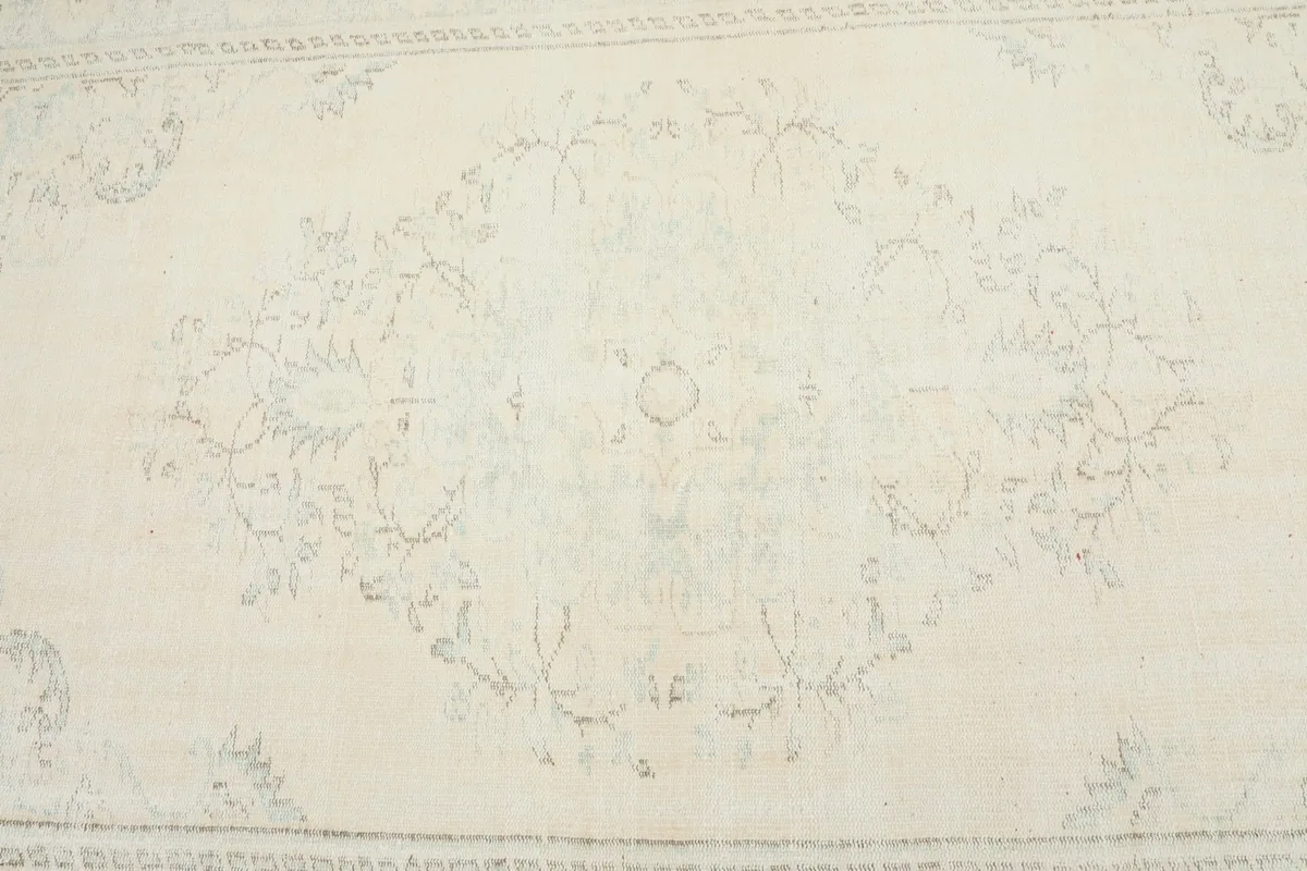 Detailed view of the central medallion motif and surrounding floral patterns