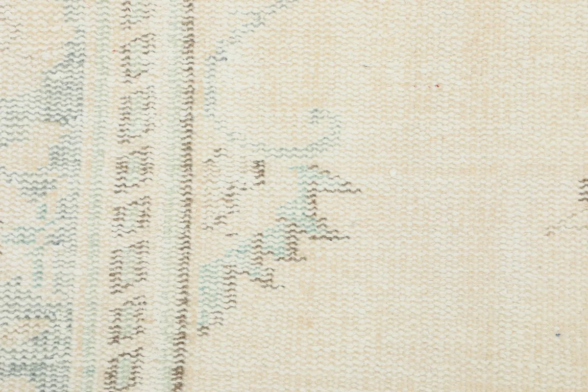 Close-up of the rug's reverse side, showing the hand-knotted cotton foundation