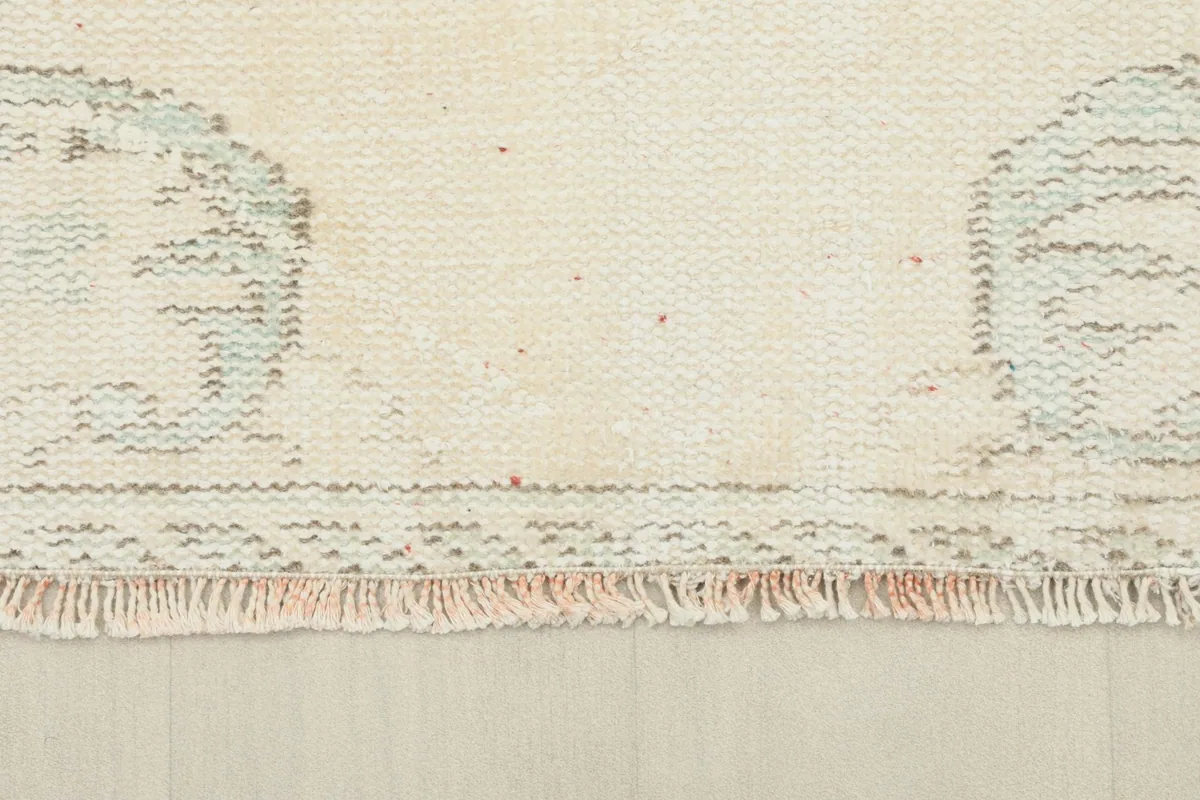 Detail of the rug's fringe and the low pile texture at the edge