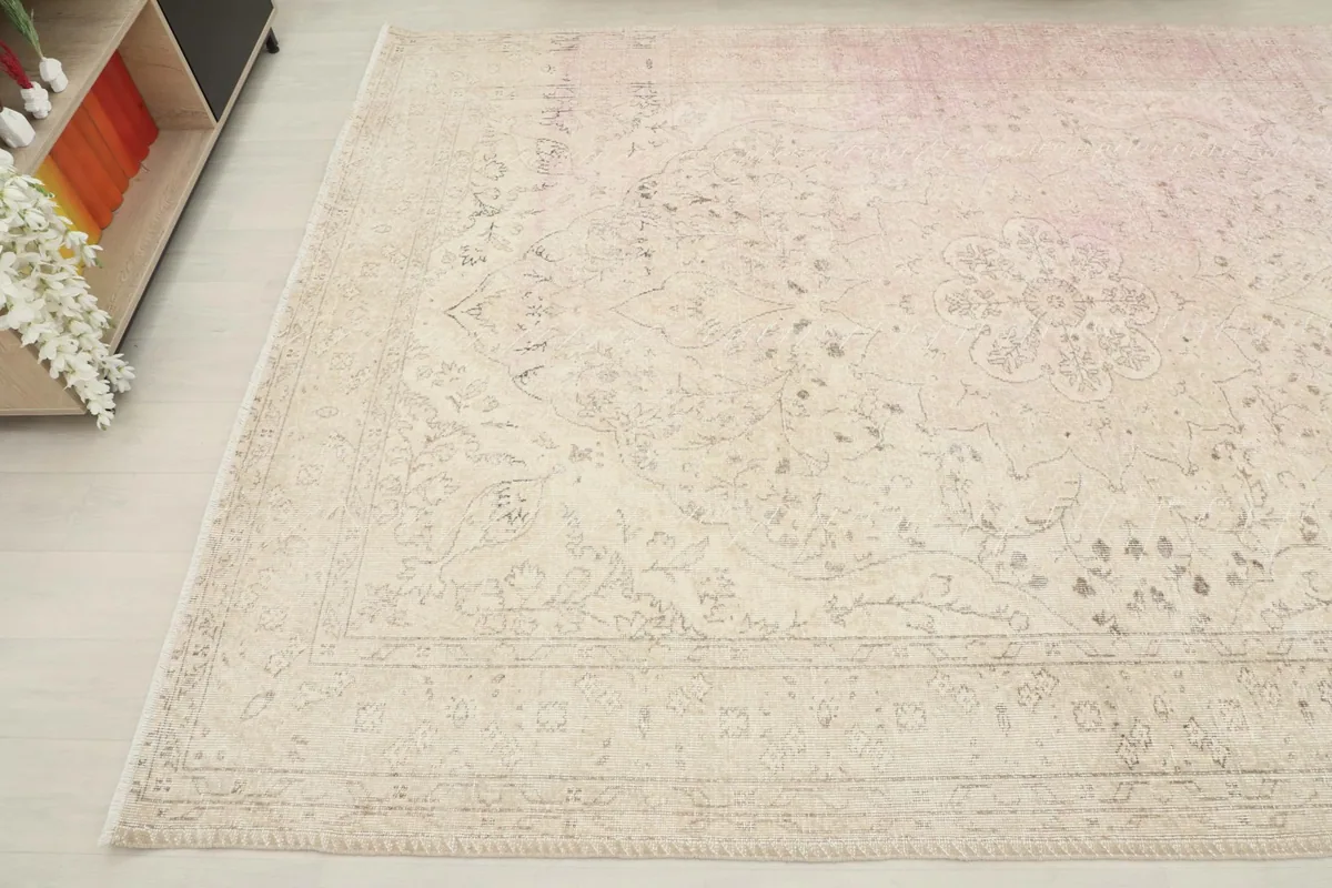 Another angled perspective of the large area rug, showing the border design and color variations