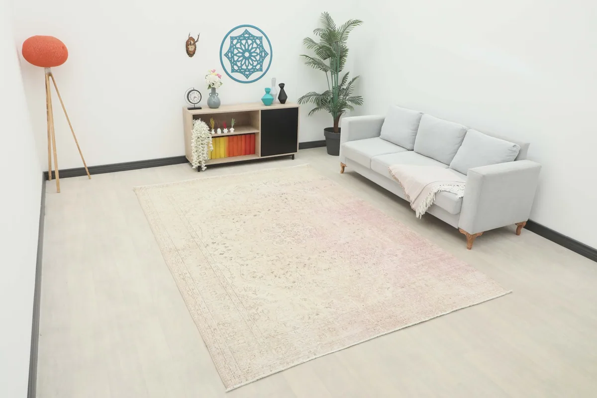 Large vintage area rug in a living room setup with a gray sofa and modern decor