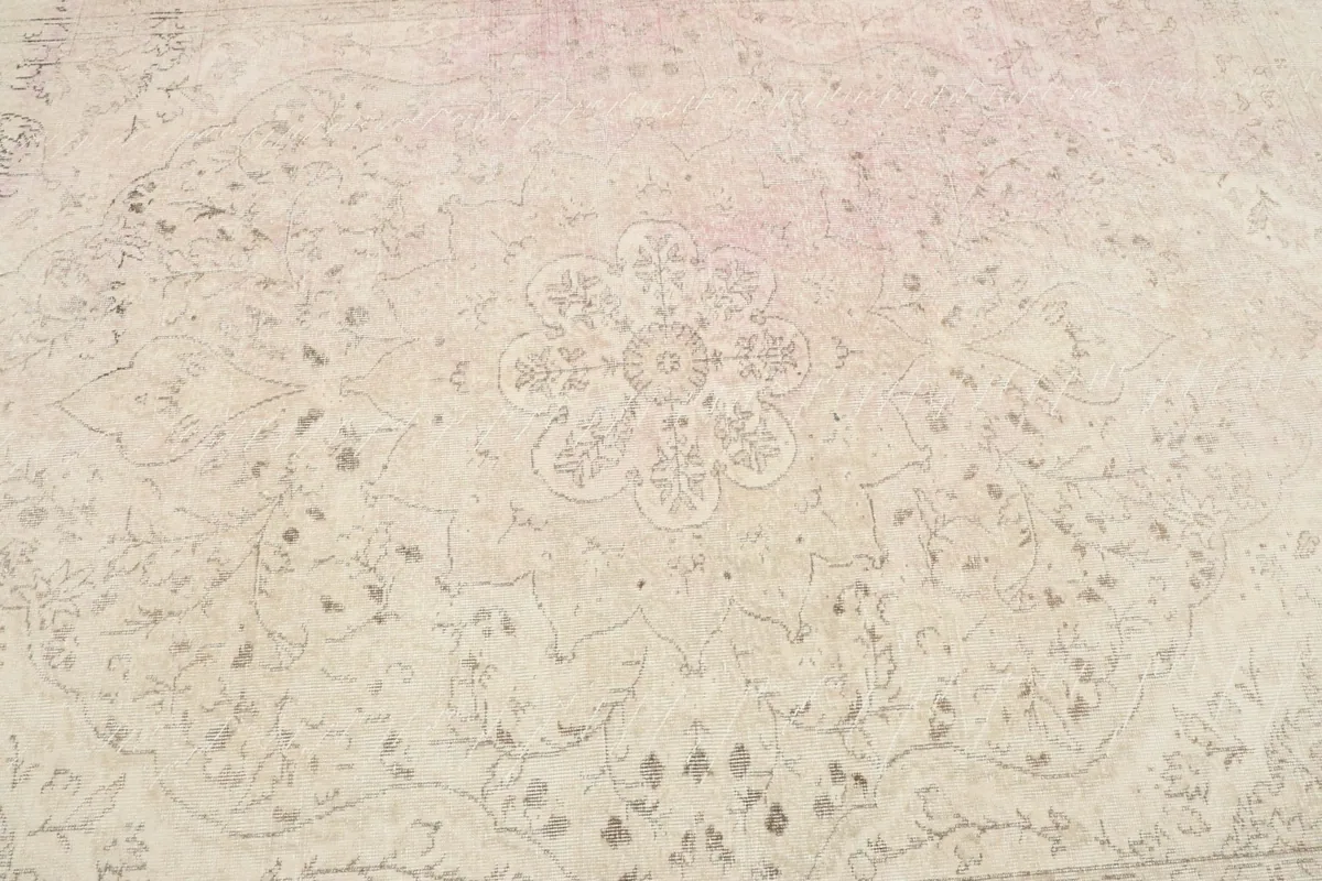 Detailed view of the central medallion and floral motifs on the vintage wool rug