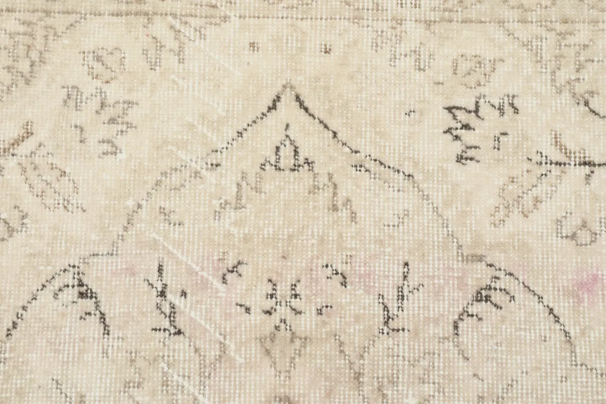 Close-up of the intricate patterns and low pile texture of the hand-knotted rug