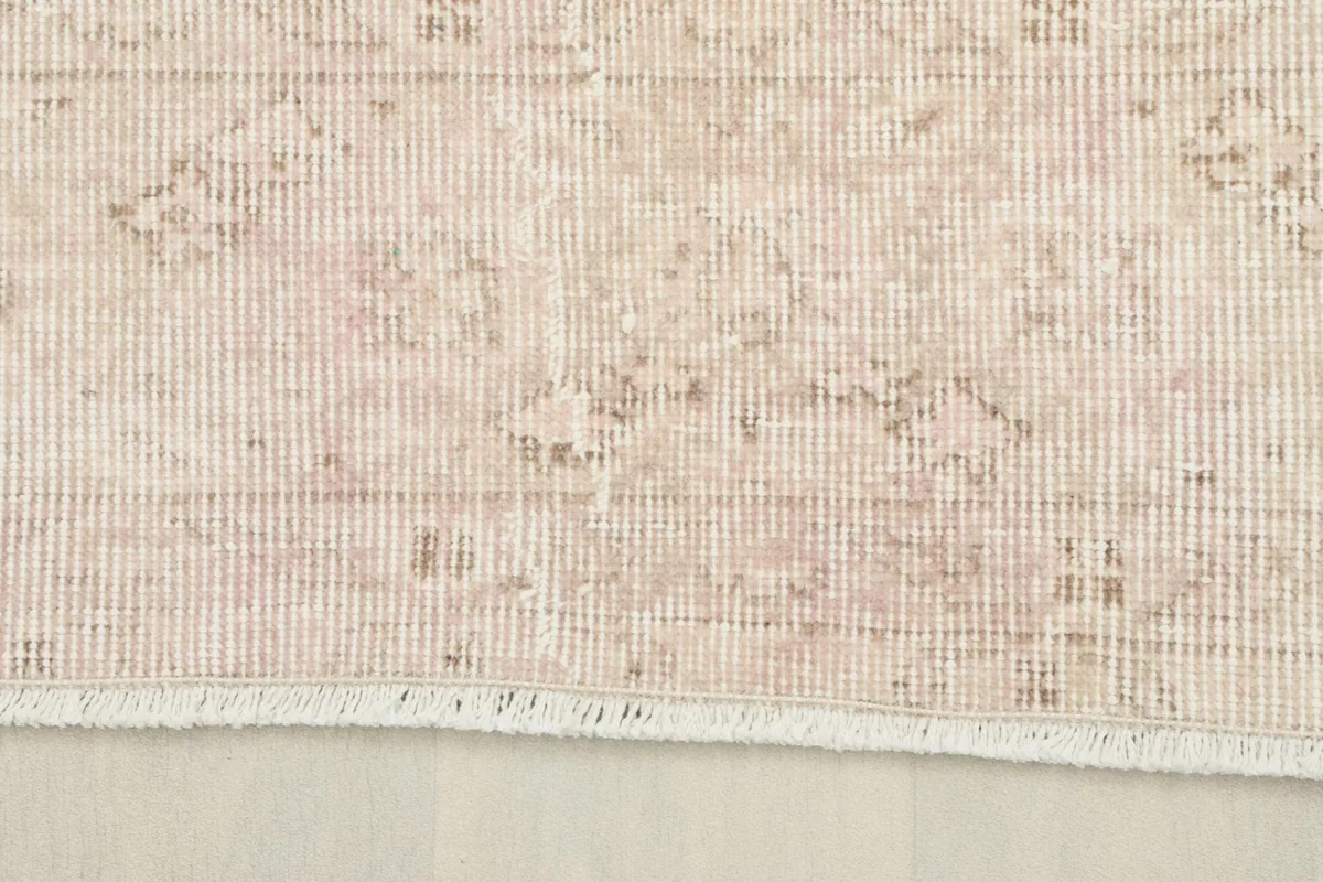 View of the low wool pile and the hand-knotted construction of the vintage rug