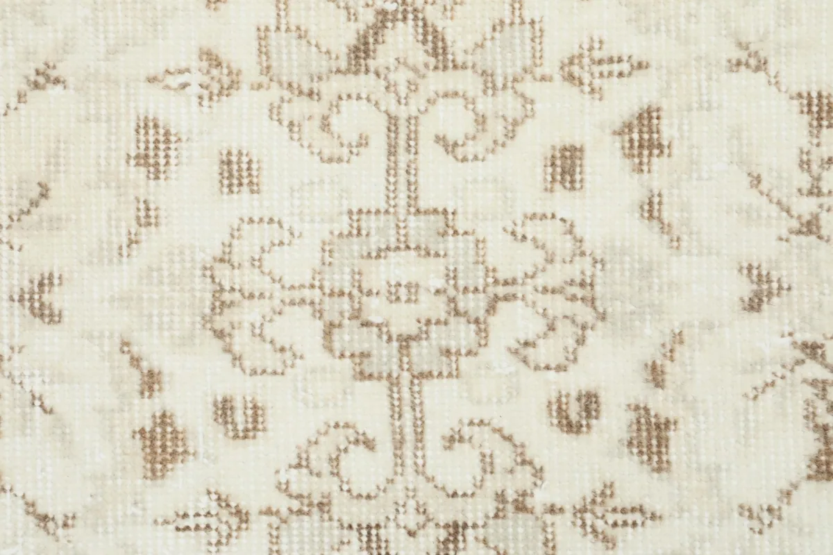 Close-up of a single stylized floral motif, showing the texture and low pile