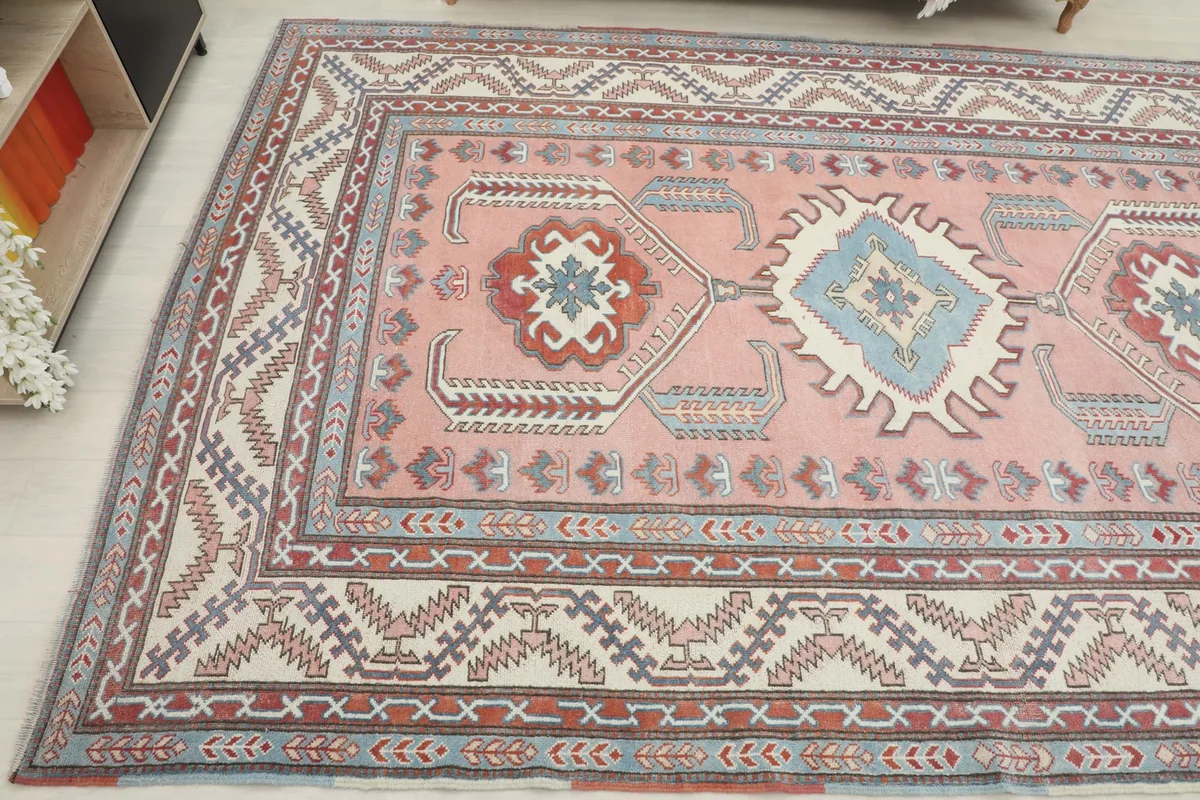 Angled perspective of the rug, focusing on the intricate details of the border and central motifs
