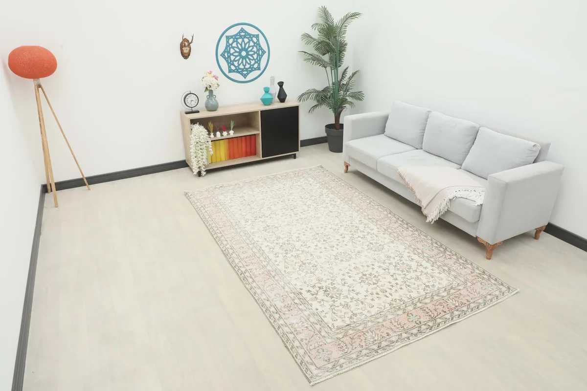 Vintage Anatolian 6x9 area rug displayed in a bright living room setting with a sofa