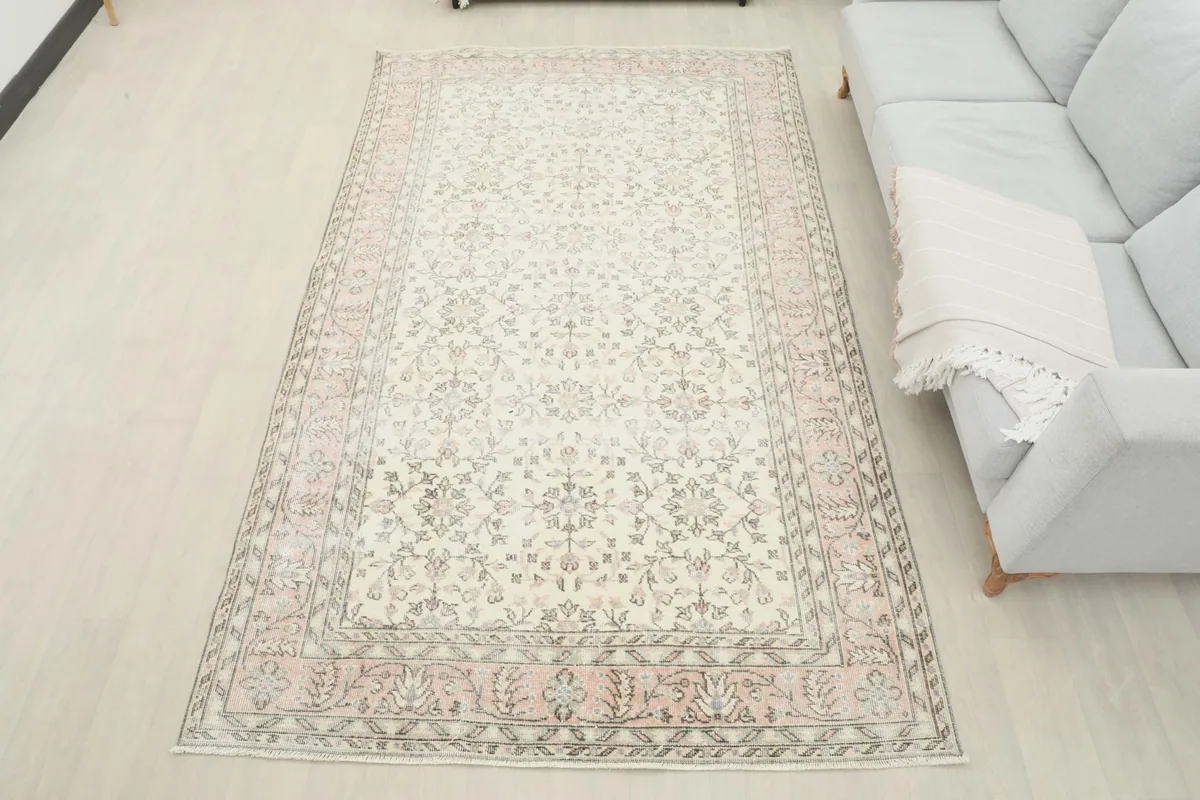 Overhead view of the 6x9 ivory and rose rug in a room, offering a full perspective