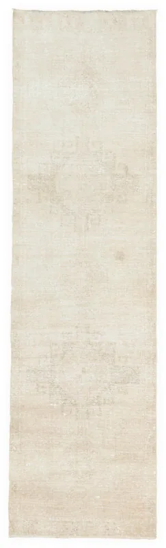Full overhead view of the beige vintage hand-knotted runner rug on a white background.