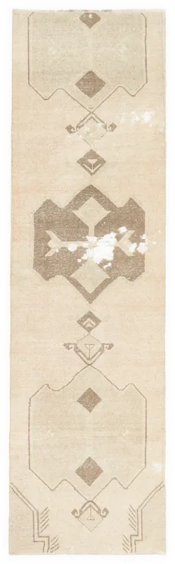 Full overhead view of the beige and brown tribal geometric runner rug on a white background.