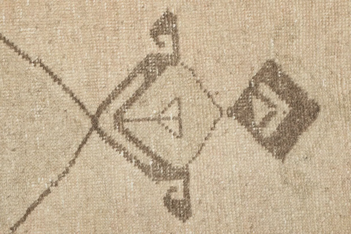 Macro detail of a specific tribal motif, showing the hand-knotted wool texture.