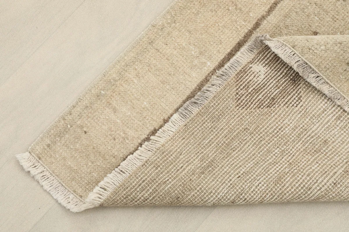 Underside of the rug, revealing the cotton foundation and hand-knotted construction.