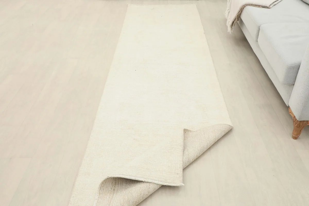 The runner partially folded, showcasing both the pile and the sturdy cotton foundation.