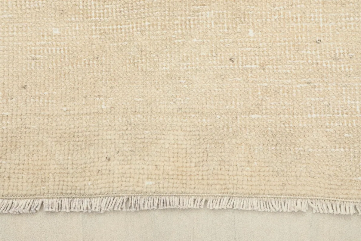 Close-up of the short, natural cotton fringes at the end of the vintage Anatolian runner rug.