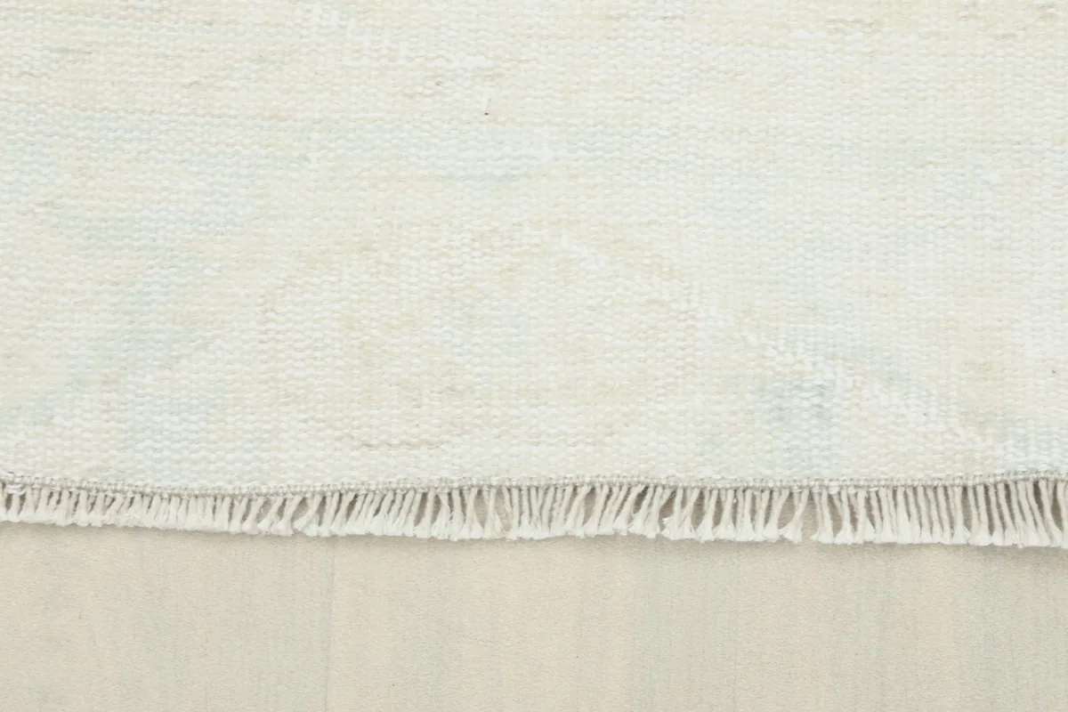 Close-up of the short, hand-finished fringe and edge of the rug