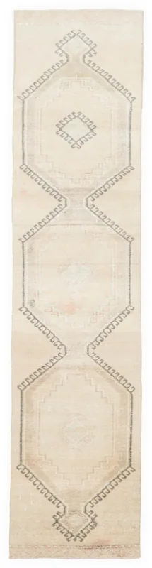 Full top view of the ivory and gray geometric vintage Anatolian runner rug on a white background.
